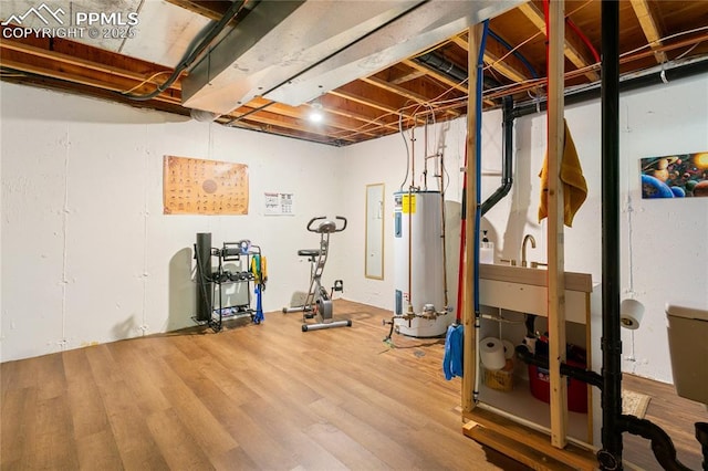 5585 Tamworth Dr, Colorado Springs, CO 80919 - workout area featuring gas water heater and wood finished floors