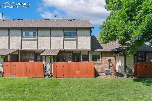 5585 Tamworth Dr, Colorado Springs, CO 80919 - back of property with a gate, brick siding, and stucco siding