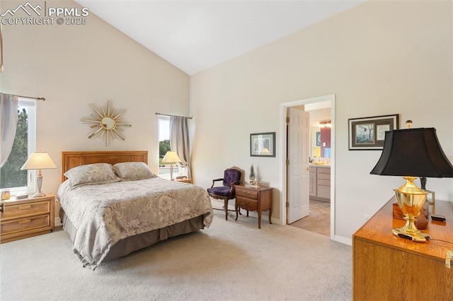 1690 Doe Run Pt, Colorado Springs, CO 80919 - carpeted bedroom featuring high vaulted ceiling and ensuite bathroom