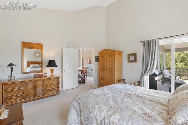 1690 Doe Run Pt, Colorado Springs, CO 80919 - bedroom with light colored carpet, access to exterior, and a towering ceiling