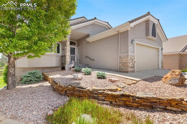 1690 Doe Run Pt, Colorado Springs, CO 80919 - view of front of home with stucco siding, stone siding, driveway, a garage, and a tile roof