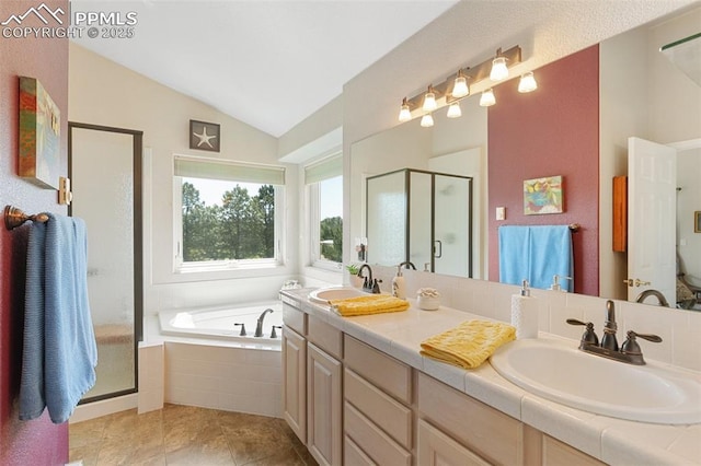 1690 Doe Run Pt, Colorado Springs, CO 80919 - bathroom featuring lofted ceiling, a stall shower, a garden tub, double vanity, and tile patterned floors