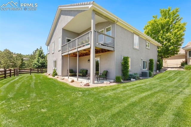 1690 Doe Run Pt, Colorado Springs, CO 80919 - back of property with stucco siding and a patio