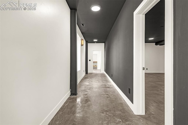 11910 Green Acres Ln, Colorado Springs, CO 80908 - hallway featuring finished concrete flooring and baseboards