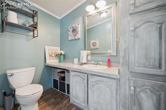 5664 Southfork Dr, Peyton, CO 80831 - bathroom featuring crown molding, vanity, wood finished floors, and a textured ceiling