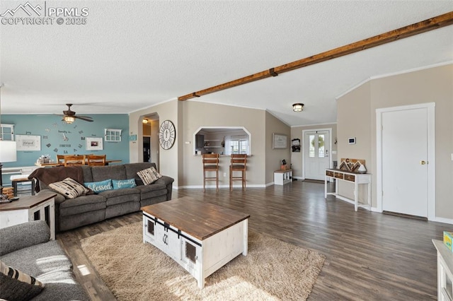 5664 Southfork Dr, Peyton, CO 80831 - living area featuring dark wood finished floors, ceiling fan, a textured ceiling, arched walkways, and ornamental molding