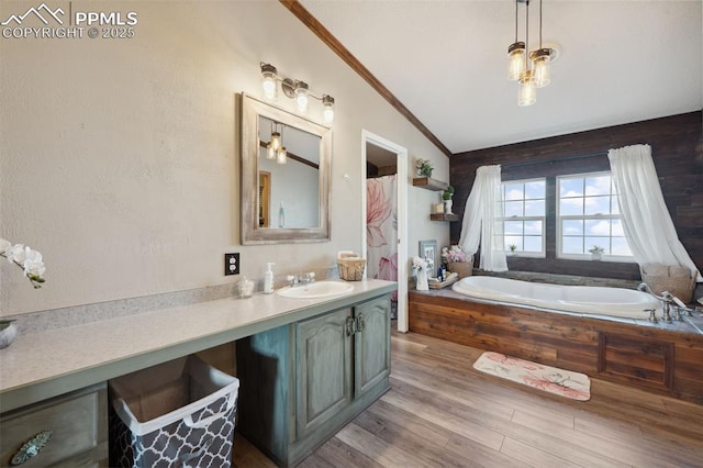 5664 Southfork Dr, Peyton, CO 80831 - full bath with vanity, a garden tub, wood finished floors, and ornamental molding