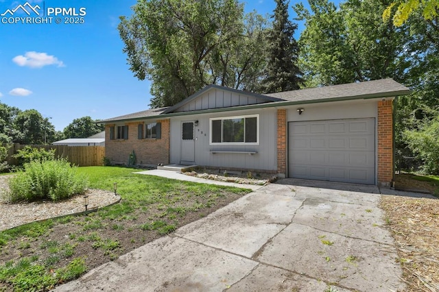 906 Bowser Dr, Colorado Springs, CO 80909 - ranch-style home featuring a garage, brick siding, concrete driveway, and board and batten siding