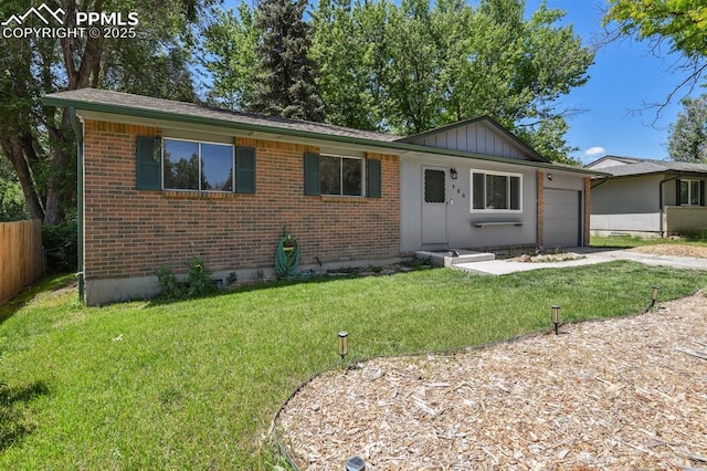 906 Bowser Dr, Colorado Springs, CO 80909 - ranch-style home with brick siding, board and batten siding, an attached garage, and concrete driveway