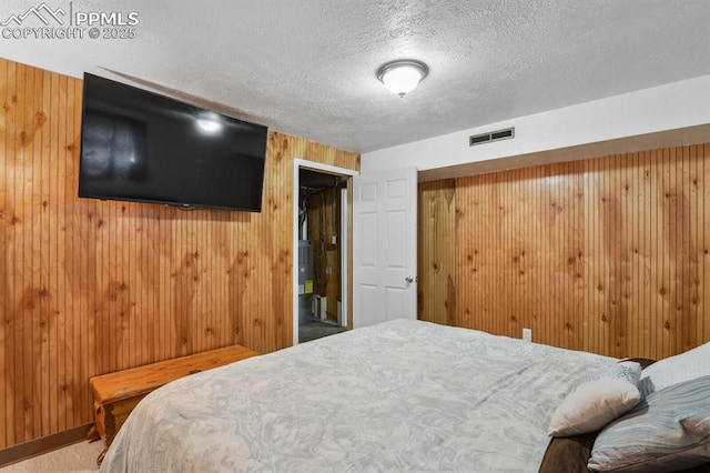 906 Bowser Dr, Colorado Springs, CO 80909 - bedroom featuring a textured ceiling and wooden walls