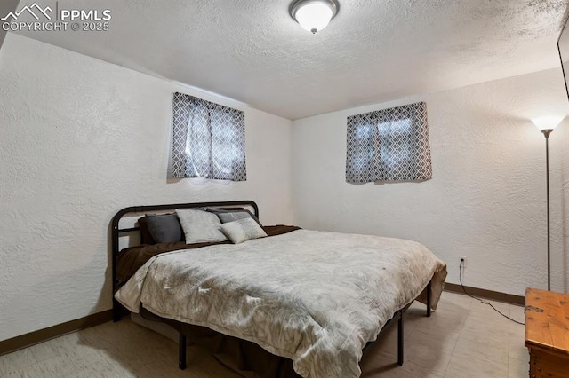906 Bowser Dr, Colorado Springs, CO 80909 - bedroom with a textured wall, a textured ceiling, and tile patterned floors