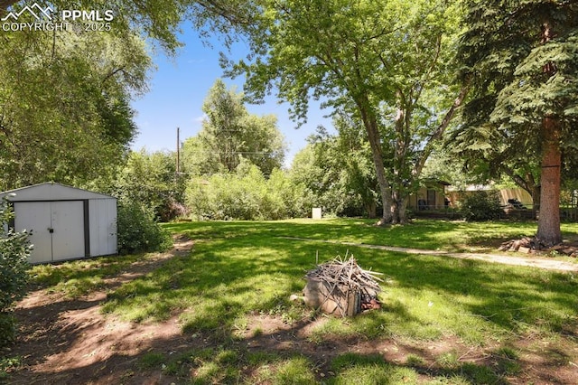 906 Bowser Dr, Colorado Springs, CO 80909 - view of green lawn featuring a storage shed