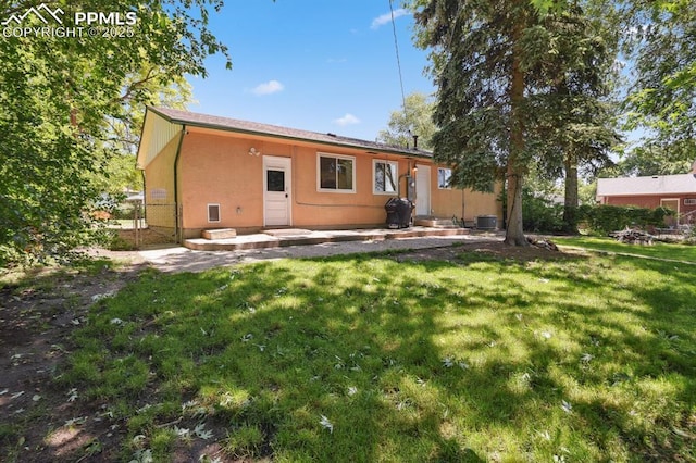 906 Bowser Dr, Colorado Springs, CO 80909 - rear view of house with a patio and stucco siding