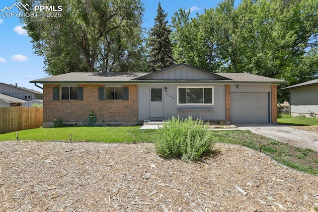 906 Bowser Dr, Colorado Springs, CO 80909 - ranch-style home with an attached garage, concrete driveway, brick siding, and board and batten siding