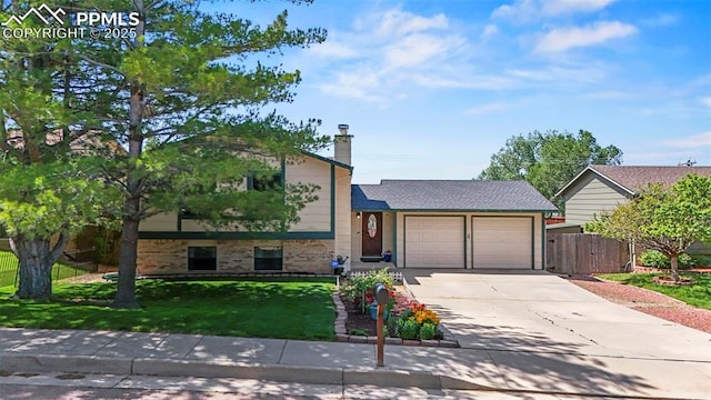 7385 Powderwash Dr, Colorado Springs, CO 80911 - split level home featuring a garage, brick siding, driveway, and a chimney