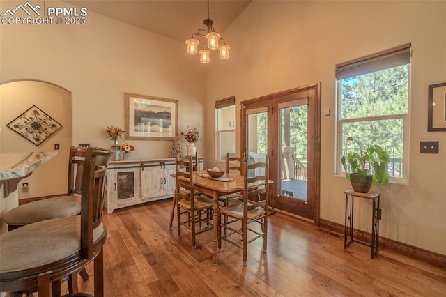 15324 Pole Pine Pt, Colorado Springs, CO 80908 - dining space with wood finished floors, healthy amount of natural light, and a chandelier