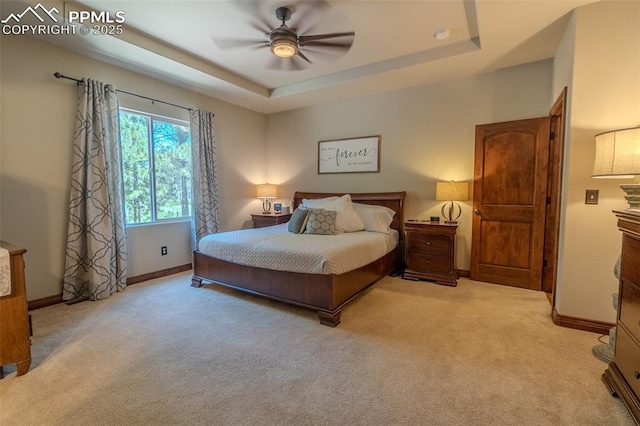 15324 Pole Pine Pt, Colorado Springs, CO 80908 - bedroom featuring light carpet, a tray ceiling, and ceiling fan