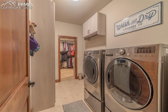 15324 Pole Pine Pt, Colorado Springs, CO 80908 - washroom featuring cabinet space, washing machine and dryer, and light tile patterned floors