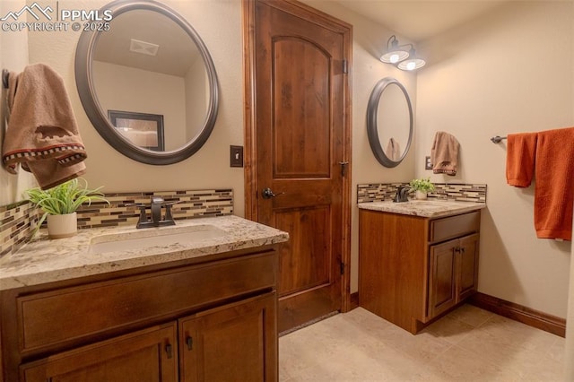 15324 Pole Pine Pt, Colorado Springs, CO 80908 - bathroom with decorative backsplash, two vanities, and tile patterned floors