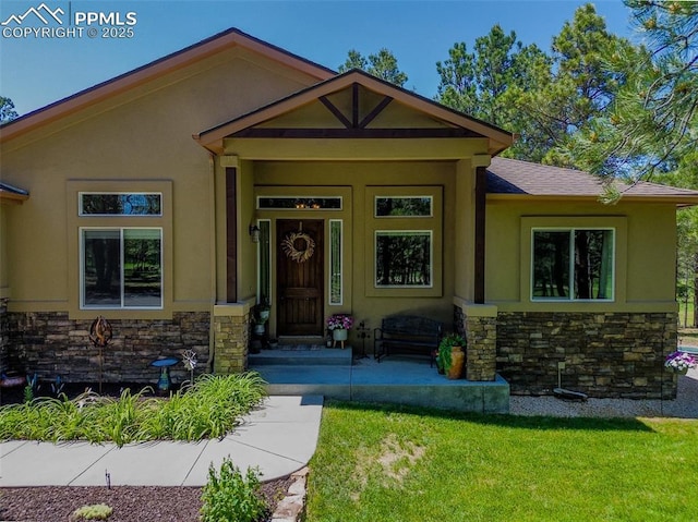 15324 Pole Pine Pt, Colorado Springs, CO 80908 - view of front facade with stone siding, stucco siding, and a front lawn
