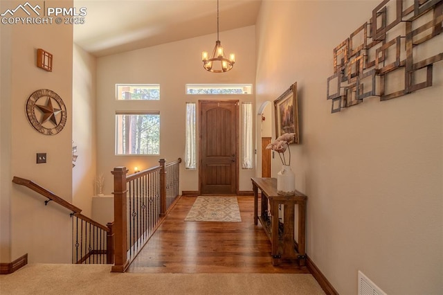 15324 Pole Pine Pt, Colorado Springs, CO 80908 - foyer with a chandelier, wood finished floors, and a towering ceiling