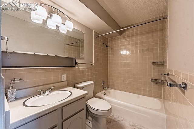 411 Lakewood Cir Unit B527, Colorado Springs, CO 80910 - bathroom featuring tile walls, bathing tub / shower combination, vanity, tasteful backsplash, and a textured ceiling