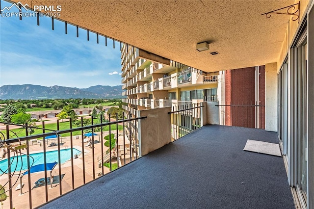 411 Lakewood Cir Unit B527, Colorado Springs, CO 80910 - balcony featuring a mountain view and view of pool area