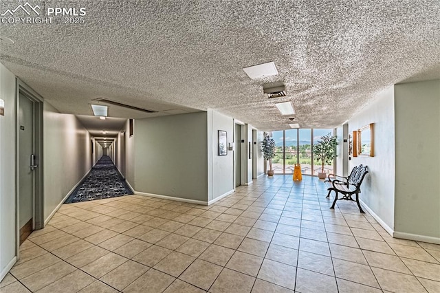 411 Lakewood Cir Unit B527, Colorado Springs, CO 80910 - corridor featuring light tile patterned floors and a textured ceiling