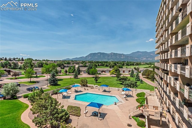411 Lakewood Cir Unit B527, Colorado Springs, CO 80910 - community pool with a patio area and a mountain view