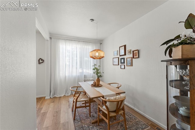 1773 Herd St, Colorado Springs, CO 80910 - dining area featuring light wood-type flooring and a textured wall