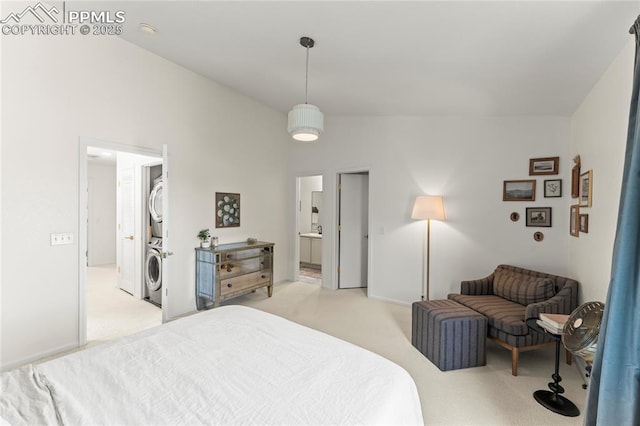 1773 Herd St, Colorado Springs, CO 80910 - bedroom with stacked washing machine and dryer, light colored carpet, and ensuite bath
