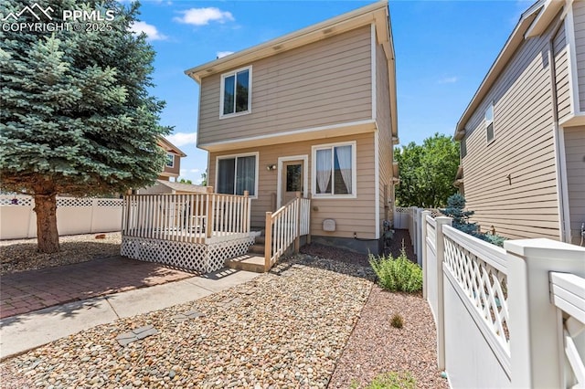 1773 Herd St, Colorado Springs, CO 80910 - view of front of house with a fenced backyard and a deck