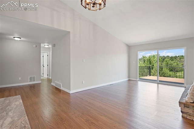 110 Fox Hill Ln, Colorado Springs, CO 80919 - unfurnished living room featuring wood finished floors, a chandelier, and lofted ceiling