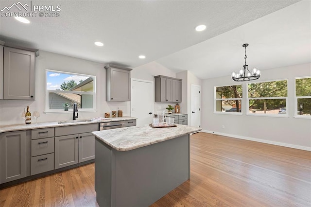 110 Fox Hill Ln, Colorado Springs, CO 80919 - kitchen with gray cabinetry, light wood-style floors, healthy amount of natural light, a chandelier, and lofted ceiling