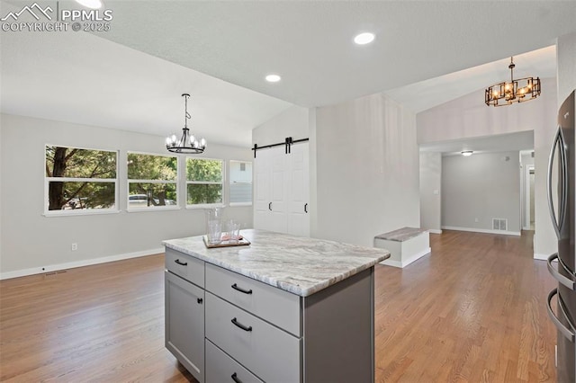110 Fox Hill Ln, Colorado Springs, CO 80919 - kitchen featuring a chandelier, vaulted ceiling, freestanding refrigerator, gray cabinetry, and light wood-style floors
