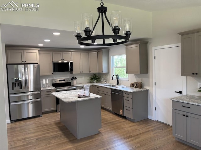 110 Fox Hill Ln, Colorado Springs, CO 80919 - kitchen featuring stainless steel appliances, gray cabinetry, a chandelier, light stone counters, and recessed lighting
