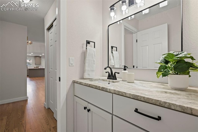 110 Fox Hill Ln, Colorado Springs, CO 80919 - bathroom with wood finished floors, vanity, and a textured wall