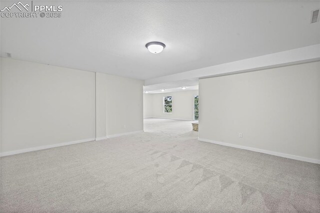 110 Fox Hill Ln, Colorado Springs, CO 80919 - carpeted spare room with baseboards and a textured ceiling