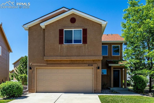 5718 Badenoch Ter, Colorado Springs, CO 80923 - view of front of home with a garage, concrete driveway, and stucco siding