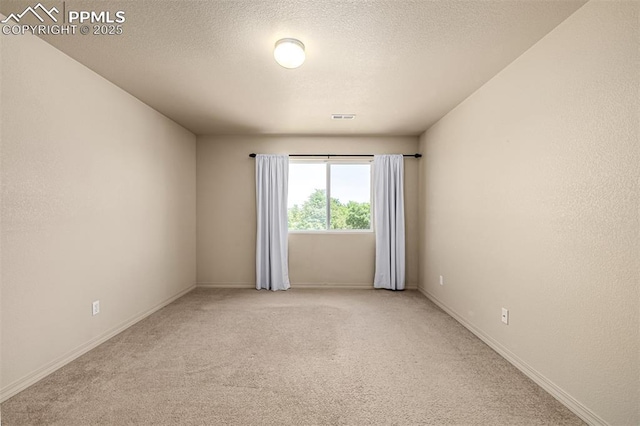 5718 Badenoch Ter, Colorado Springs, CO 80923 - unfurnished room featuring light colored carpet and a textured ceiling