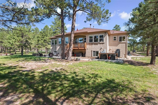 15704 Pole Pine Pt, Colorado Springs, CO 80908 - rear view of house featuring stucco siding, a lawn, and stairs