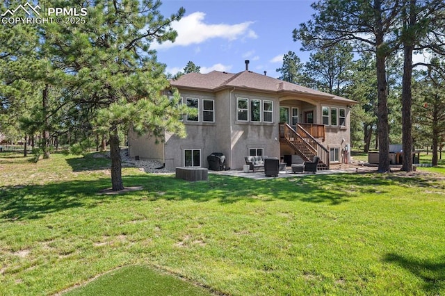 15704 Pole Pine Pt, Colorado Springs, CO 80908 - back of property with stucco siding, a patio, stairs, and a lawn