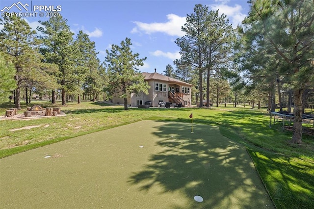15704 Pole Pine Pt, Colorado Springs, CO 80908 - view of community featuring a putting green, a trampoline, a lawn, and an outdoor fire pit