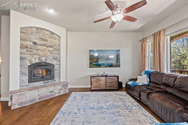15704 Pole Pine Pt, Colorado Springs, CO 80908 - living area with a fireplace, dark wood-style flooring, and a ceiling fan