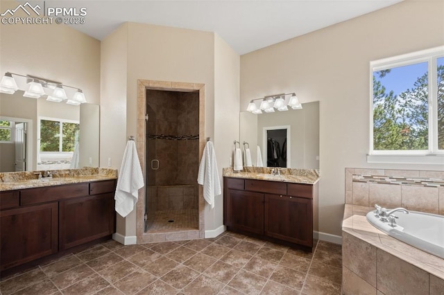 15704 Pole Pine Pt, Colorado Springs, CO 80908 - full bath featuring a shower stall, two vanities, and a bath