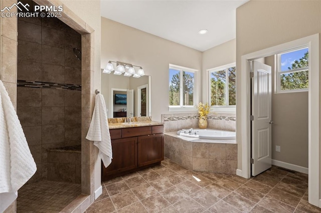 15704 Pole Pine Pt, Colorado Springs, CO 80908 - full bathroom with healthy amount of natural light, a bath, vanity, and tiled shower