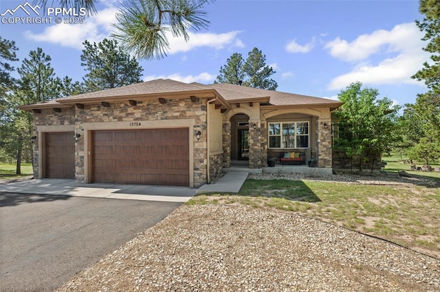 15704 Pole Pine Pt, Colorado Springs, CO 80908 - mediterranean / spanish home with driveway, stone siding, and a garage