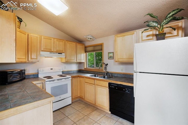 130 Oak Ln, Florissant, CO 80816 - kitchen featuring white appliances, under cabinet range hood, light brown cabinetry, tile counters, and vaulted ceiling
