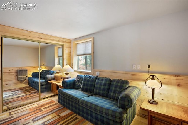 130 Oak Ln, Florissant, CO 80816 - living area with wooden walls, heating unit, and a wainscoted wall