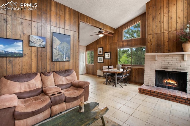 130 Oak Ln, Florissant, CO 80816 - living area featuring vaulted ceiling, wooden walls, tile patterned flooring, a brick fireplace, and a textured ceiling